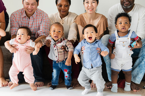 parents holding up infants | Kids Connection Childcare & Preschool